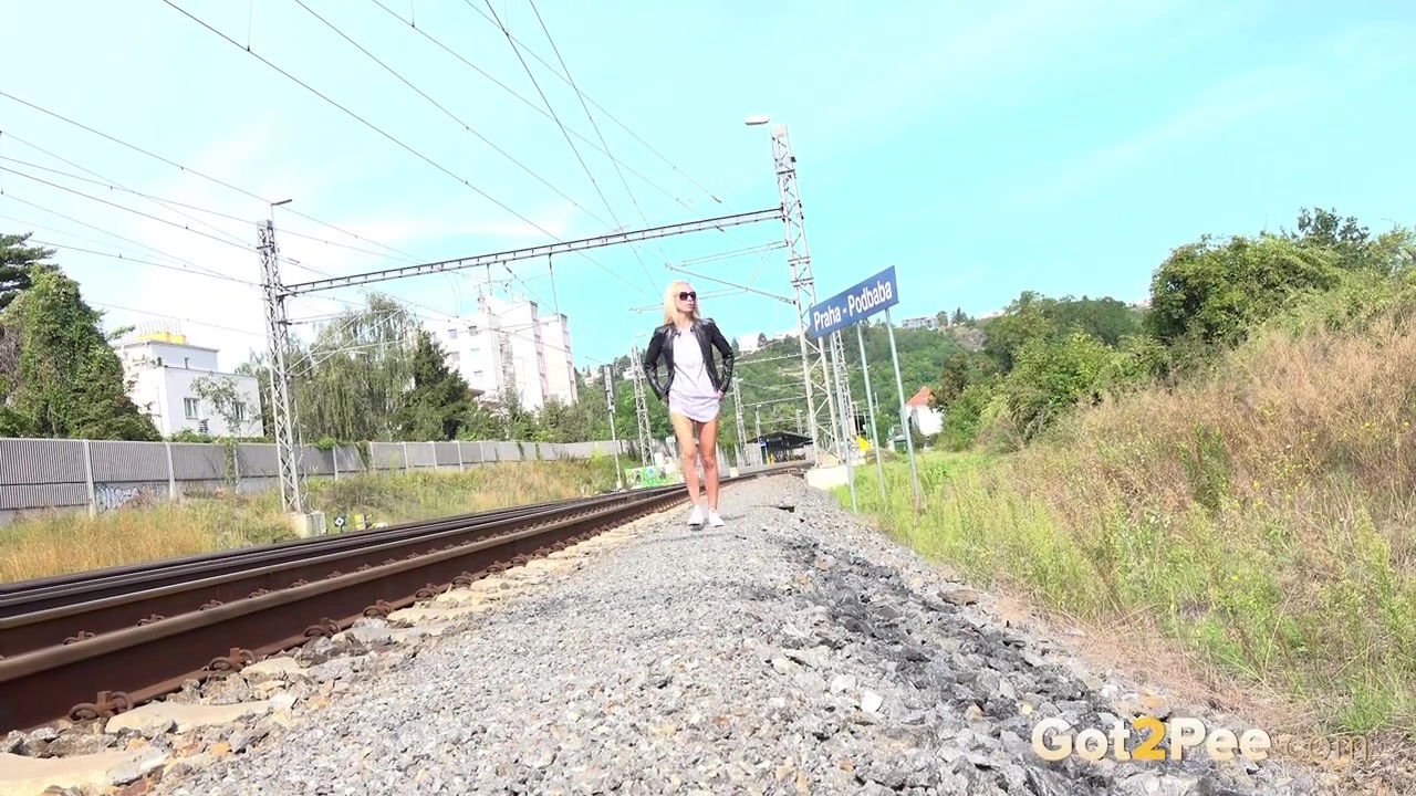 Blonde babe Debora pees next to railway line